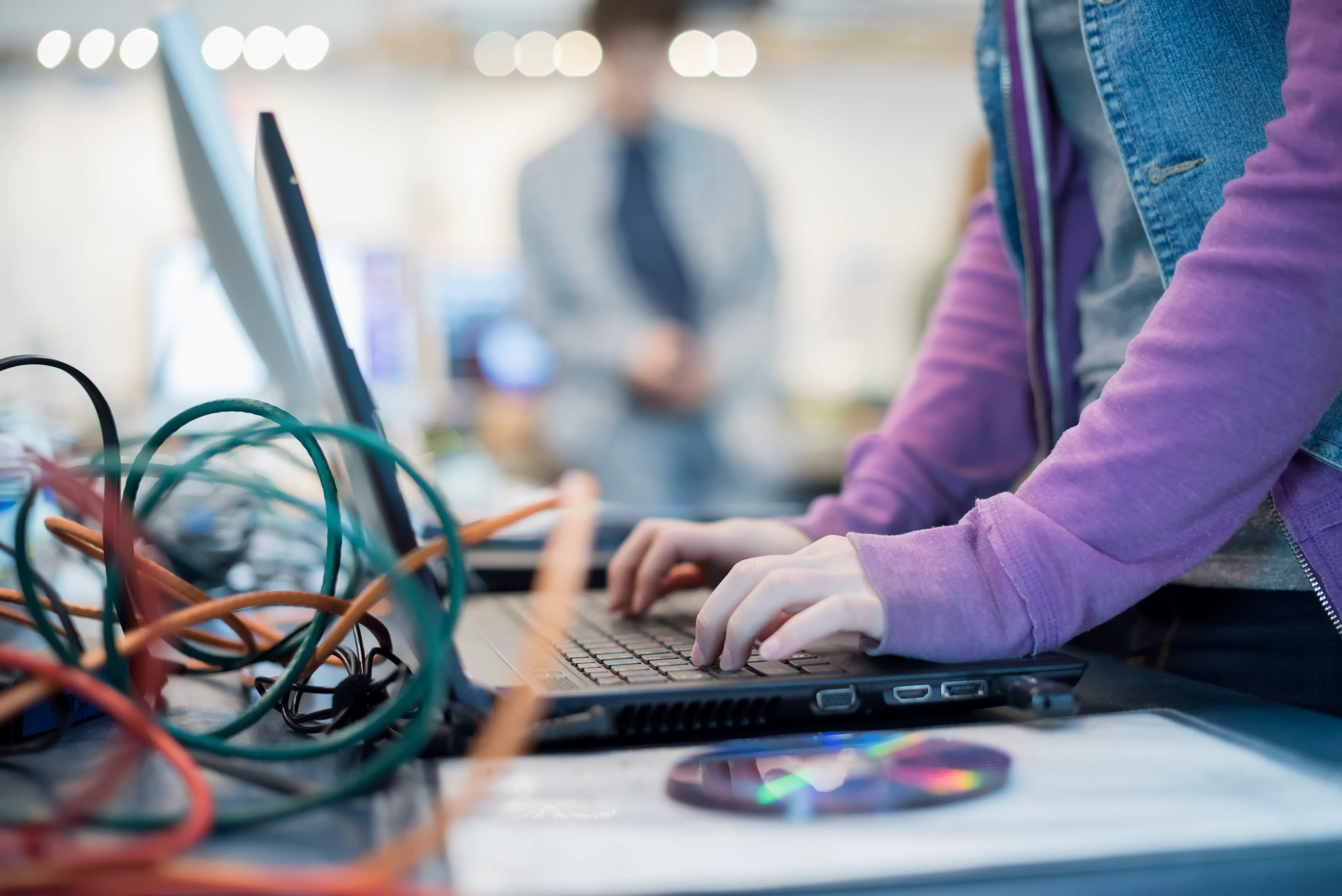 a-person-using-a-laptop-computer-disc-and-wires-o-2026-03-25-00-55-15-utc