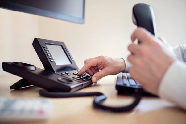 Small business internet phone systems being used for business calls and office communication.